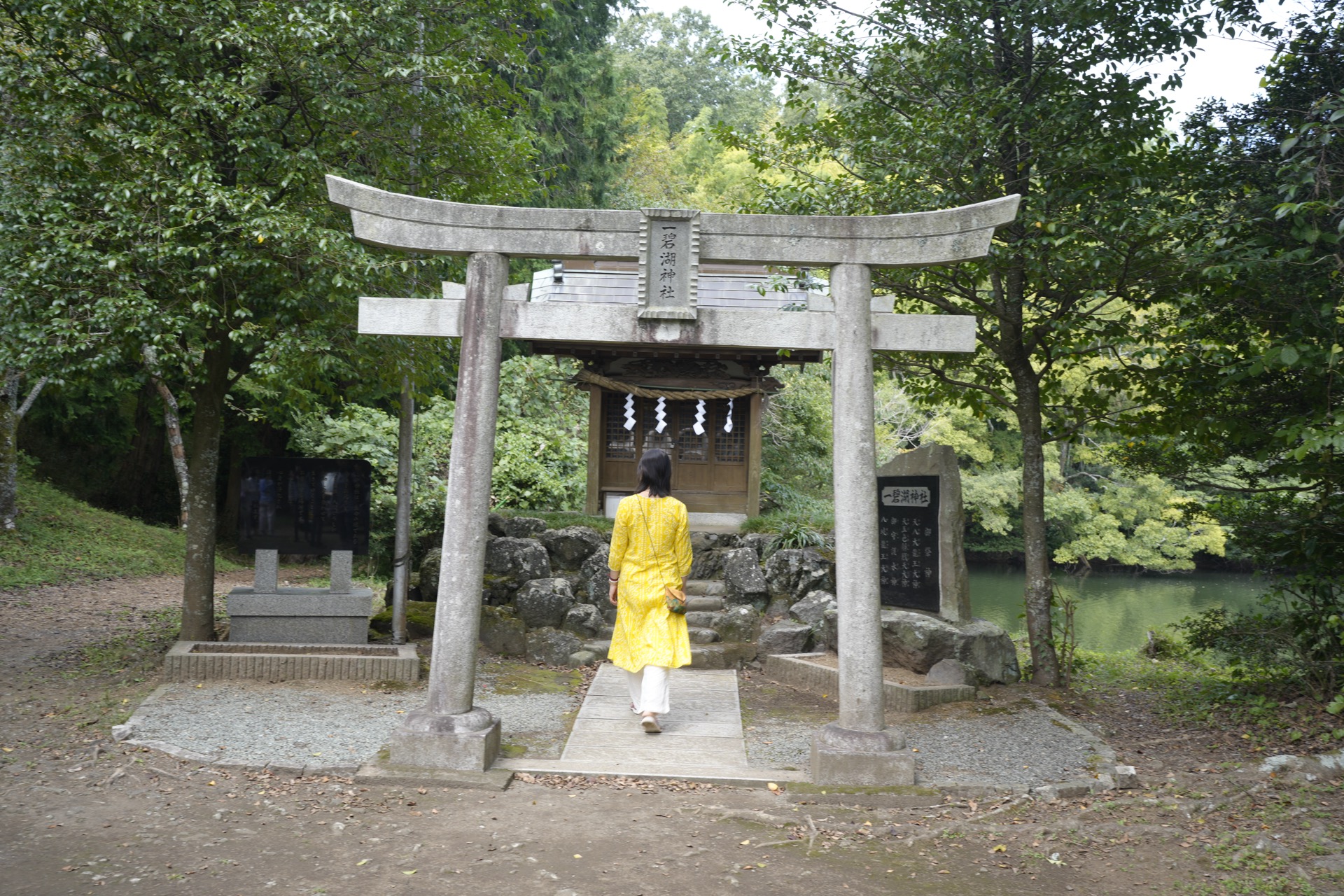 Walking through a torii gate at a forest shrine